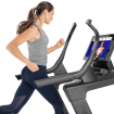 woman running on incline trainer watching screen